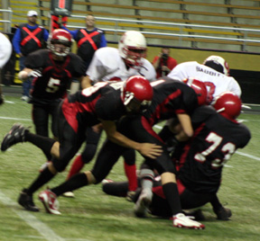 Cody Miller, David Sigler and Chase Nuxoll combine to bring down Oakley's Brian Babbitt.