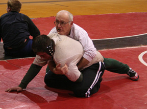 Head coach Steve Lamont demonstrates a hold with Chance Ratcliff.