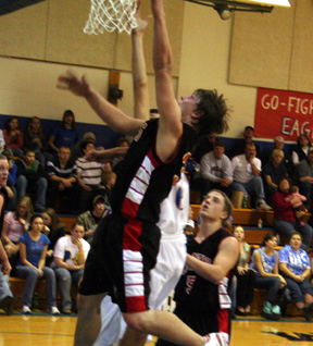 Branden Waller scores a lay-up. At right is Kyle Daly.