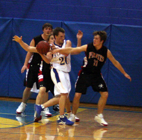 Conner Rieman knocks the ball away from Nezperce's Damon Leitch. In the back is Branden Waller and behind Leitch is David Sigler.