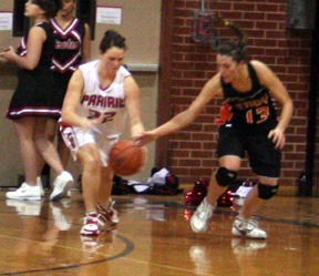 Kara Guyer steals the ball from a Troy player.