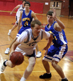 Dustin Lustig drives toward the hoop.