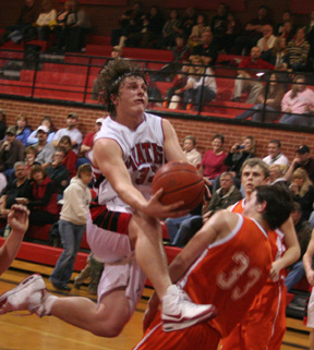 Branden Waller contorts his way to a layup against Troy.