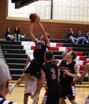 Devin Schmidt puts up a shot at Deary. Also shown are Eric Daly, 2, and Kyle Daly.