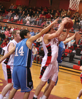 Kyle Daly appears to get smacked alongside the head as he got inside for a shot. At left is Tyler Forsmann.