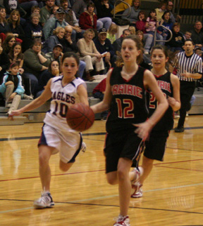 NaTosha Schaeffer stole the ball and drove for a lay-up late in the first half against Lewis County. Behind her is Amber Holthaus.