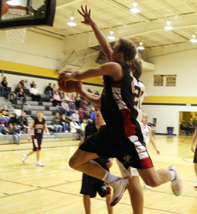 Devin Schmidt swoops in for a lay-up at Highland.