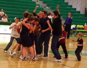 Everybody celebrates at midcourt after the final buzzer.