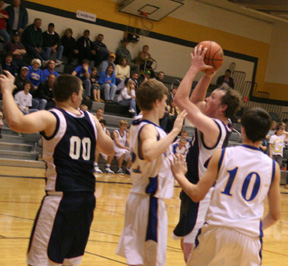 Josh Frei shoots in the Nezperce game. At left is Joseph Lustig.