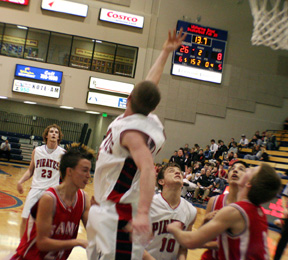 Tyler Forsmann actually made this shot that he flipped over his head off the backboard. Watching are David Sigler, 23, and Kyle Holthaus, 10.