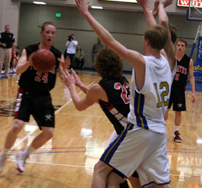 David Sigler passes out of a double team to Tyler Forsmann. At right is Kyle Daly.