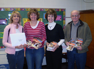 Shown from left are Renee Eckert, Sherry Holthaus and Mary and John Funke. The Funkes have donated books to Prairie Middle School.