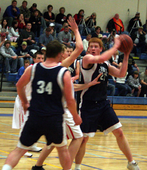 David Johnson looks to pass against Mackay. In the foreground is Chase Nuxoll.