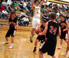 Kyle Daly passes to his brother Eric in the Cascade game. At right are Tyler Forsmann and Branden Waller.