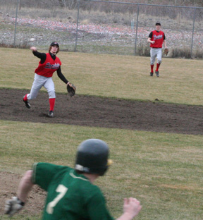 David Sigler makes a throw from shortstop to put out a Culdesac runner. At right is leftfielder Eric Daly.