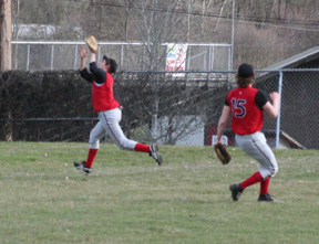 Tyler Rogers makes a catch in left field against Kamiah. At right is shortstop David Sigler.