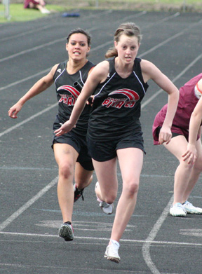 Justina Zigler hands the baton to NaTosha Schaeffer in the 4x200 relay. They teamed with Kristin Hill and MaKayla Schaeffer to take 3rd in the event.
