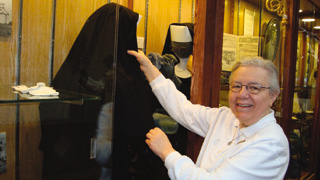 Sister Bernice Wessels, Museum Technician, adjusts a display, 2009. The Historical Museum at St. Gertrude houses an extensive collection of religious artifacts that tell the story of the Benedictine Sisters of Cottonwood.