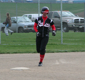 Kara Guyer is rounding second in her home run trot after hitting one over the fence in the first Genesee game.