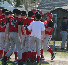 Ronnie Chandler gets high fives at home after his 2-run homer against Lewis County.