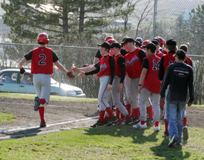 Seth Guyer is congratulated at home plate after his grand slam homer put Prairie ahead of Grangeville.