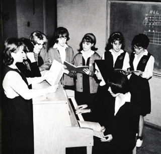 Sister Angela Uhlorn instructs a choir group at St. Gertrude's Academy, 1963.