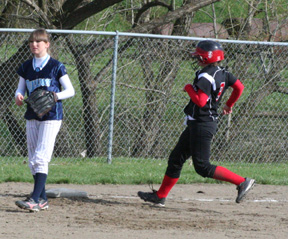 Rachel Kaschmitter cruises into third with a triple against Grangeville.