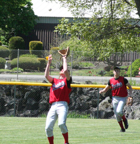 Shortstop David Sigler catches a pop up against Kendrick that got Prairie out of a first inning jam. In the background is leftfielder Kyle Daly.