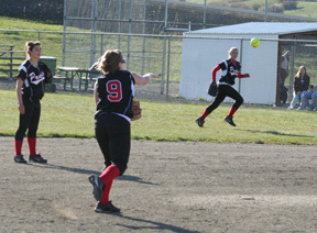 Rachel Kaschmitter guns out a Troy baserunner as Leora Laurino goes to back up the play. Also shown is second baseman Amber Holthaus.