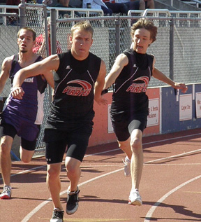 Justin Schmidt hands off to brother Devin Schmidt in the 4x400 relay. Prairie took 4th in the event.