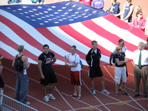 As defending state champions Kaylee Uhlenkott and Kyler Shumway helped carry in the flag during the Parade of Athletes.
