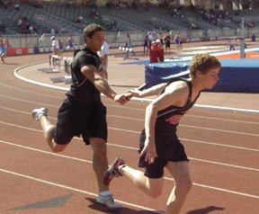 Kyler Shumway hands off to Brock Heath in the 4x200 relay.