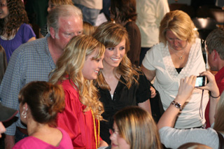 Graduate Chelsea Long poses for a photo with her father Pat and sister Briget.