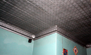 When the false ceiling was removed the original tin ceiling was exposed inside the Royale Room. It was then cleaned up and repainted.