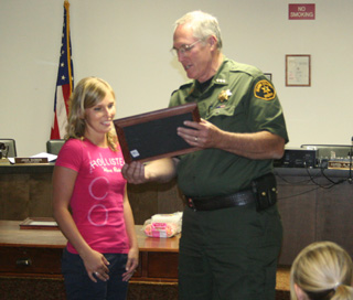 Cassi Lockett receives here award from Sheriff Doug Giddings.
