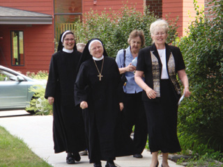 From left - Sister Rut Maria Buschor and Abbess Pia Habermacher of the San Andreas Kloster in Sarnen, Switzerland, arrive at the monastery, escorted by St. Gertrudes Sisters Cecile Marie Uhlorn and Clarissa Geockner, prioress.