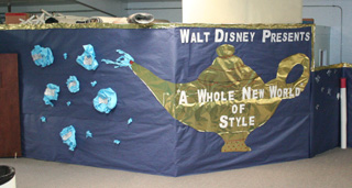 The other part of the fashion show decorations showing the theme. For the show the white poles had orange balloons on top of them.