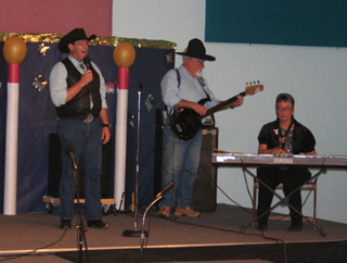 Brian Roy, left, singing