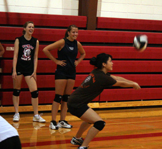 PHS volleyball co-captain Francesca Johnson makes a pass while from left Kayla Johnson and fellow co-captain Casey Bruegeman wait their turn in the drill.