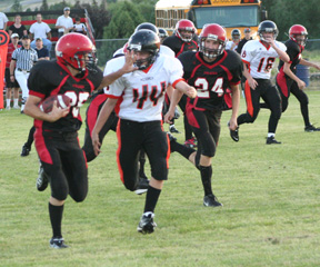 Cody Schumacher stiffarms a Kendrick defender. Also seen is Justin Schmidt, 24.