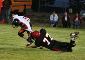 Nick Ackerman pulls down the runner by his jersey.