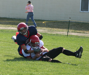 Conner Rieman cradles the ball into his chest as he scores a 2-point conversion.