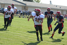 Kyle Holthaus ran through a huge hole on the left side as he heads for Prairies first score. At left is J.C. Enriquez.