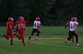 Devin Schmidt is on his way to a touchdown. He gained 48 yards on the play. At right is David Sigler.