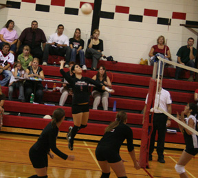 Francesca Johnson goes up for a spike against Timberline. In the foreground from left are Megan Sigler and Casey Bruegeman.