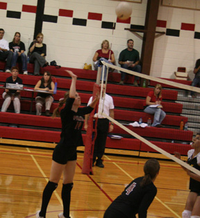 Kayla Johnson goes up for a kill against Timberline in Prairies first home match (and first win) of the season. At right is Megan Sigler.