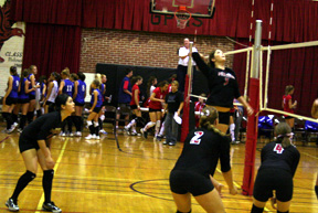 Sam Frei goes up for the kill as teammates from left Francesca Johnson, Casey Bruegeman and Megan Sigler watch and get ready for a possible return.