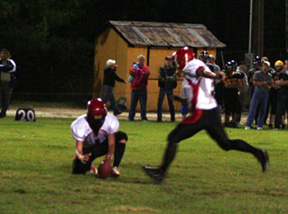 David Sigler holds as Branden Waller is about to kick 1 of 7 extra points he made against Timberline. He also kicked a 25 yard field goal but missed a try from 50 that wouldve been a school record.