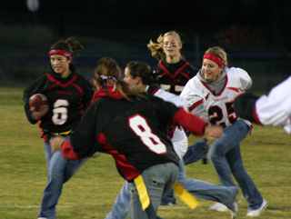 Amber Holthaus is about to be tackled by Ashley Shumway. Others shown are Alena Hoene, 8, Shelby Duman, 25 and Tanna Schlader. The black clad senior-frosh team won 30-22.