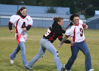 Casey Bruegeman tackles Cassie Weightman. At left is Meaghan Bruner.